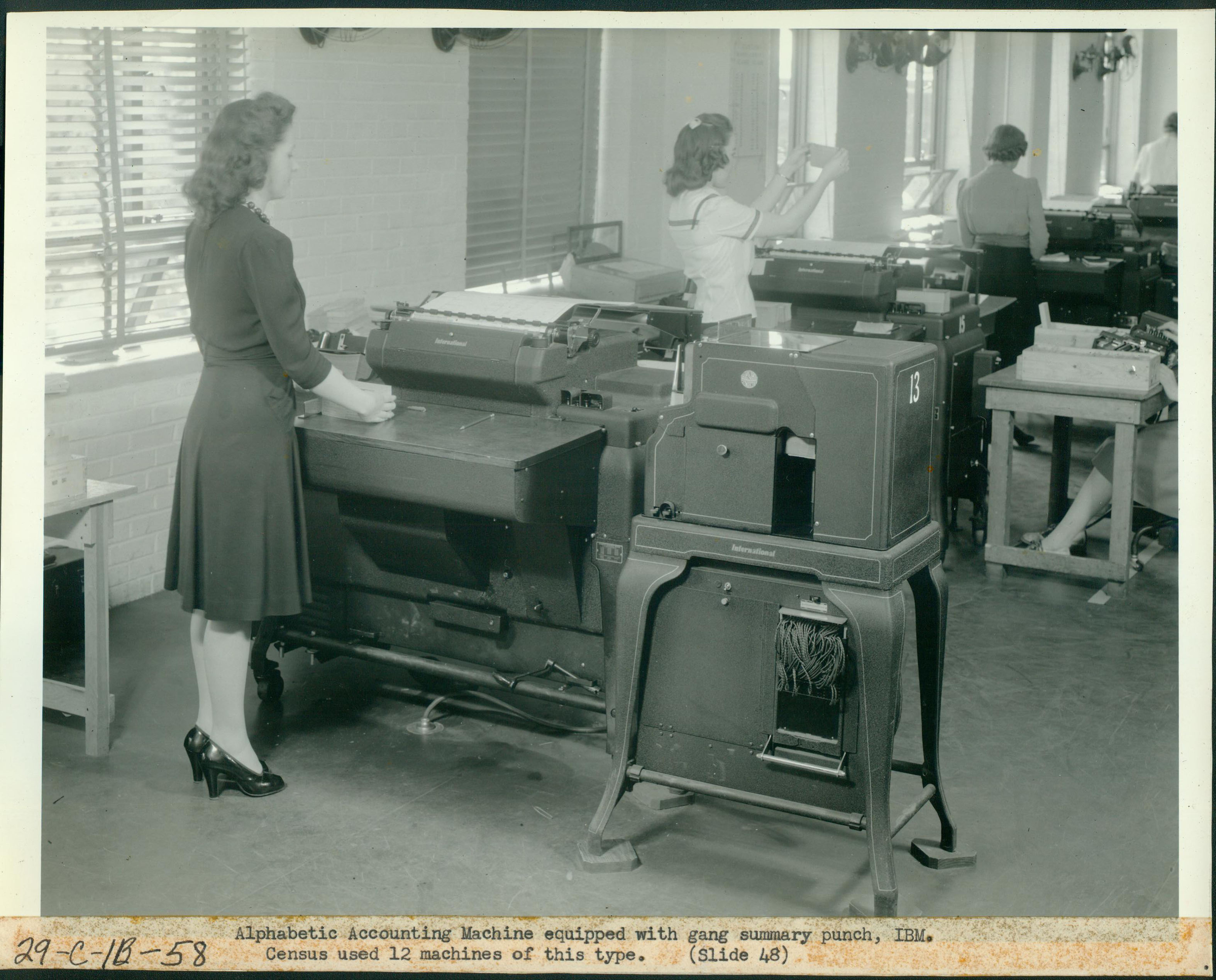 Women working at large card punching and printing machines