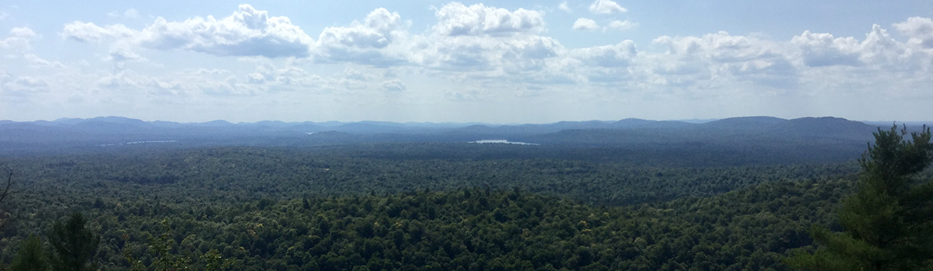 photo of landscape showing surrounding mountains and lakes